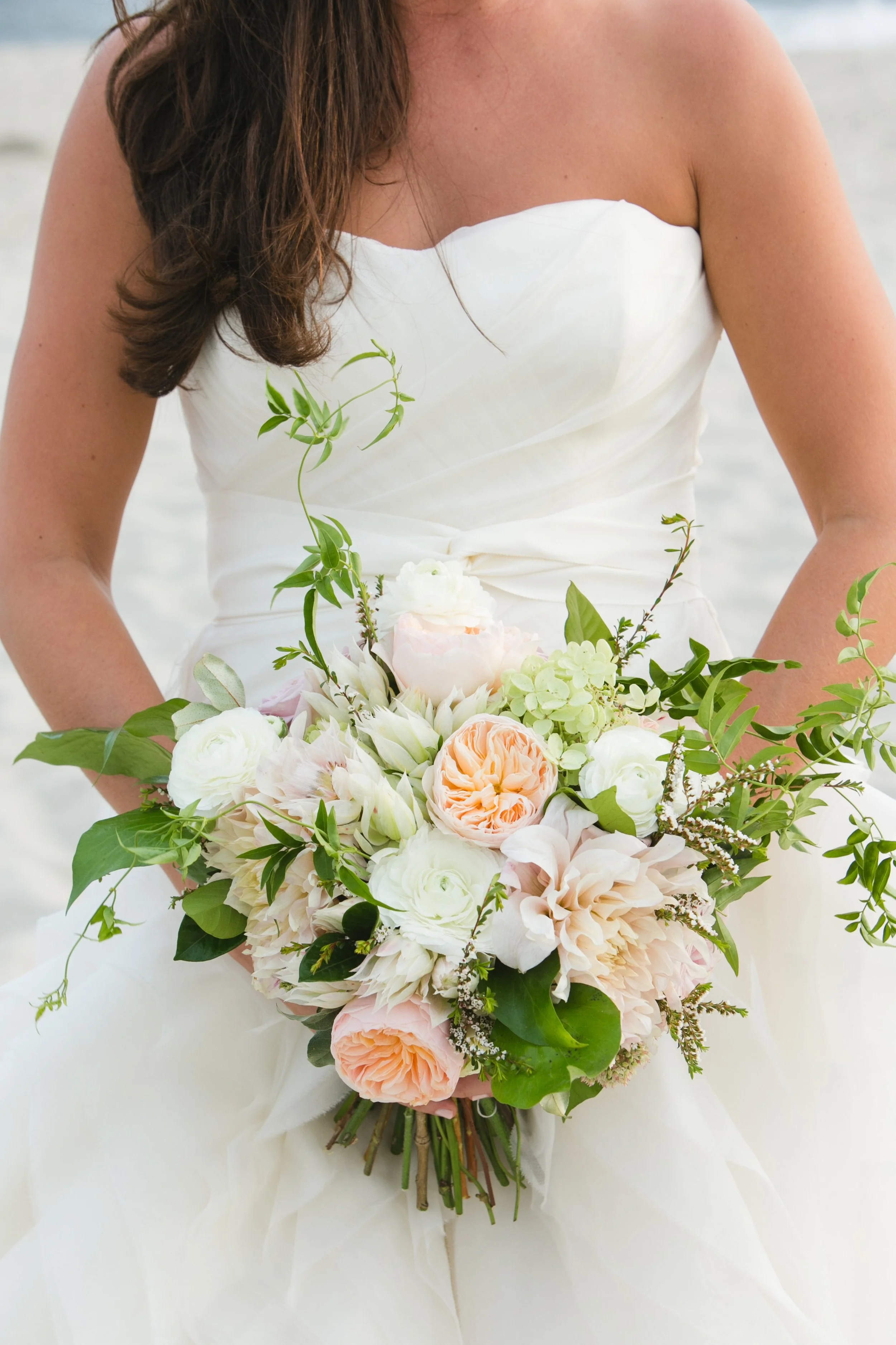 Neutral bridal bouquet with cafe au lait dahlias, peach juliet roses, ranunculus and jasmine vines