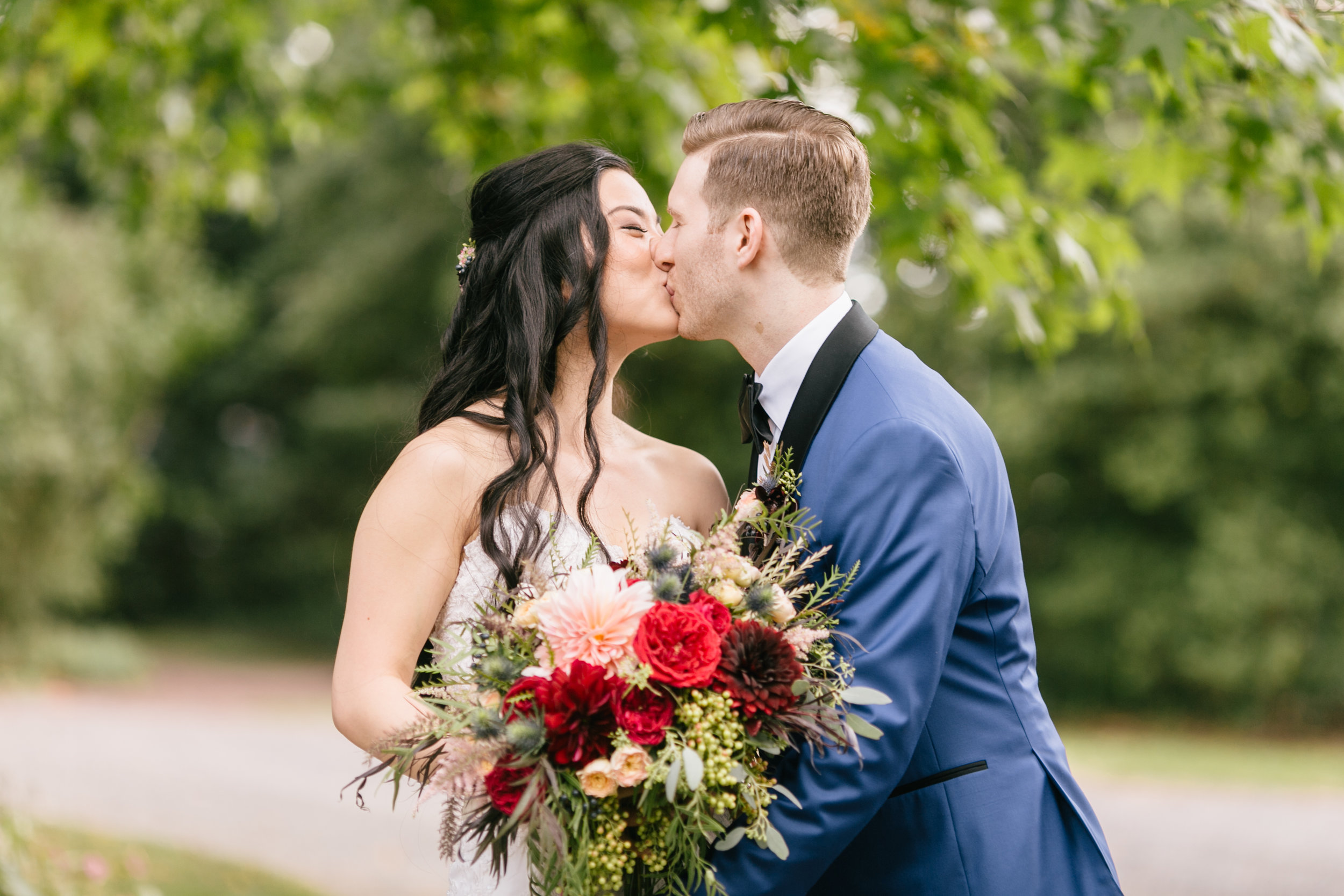 bride and groom posing with bouquet