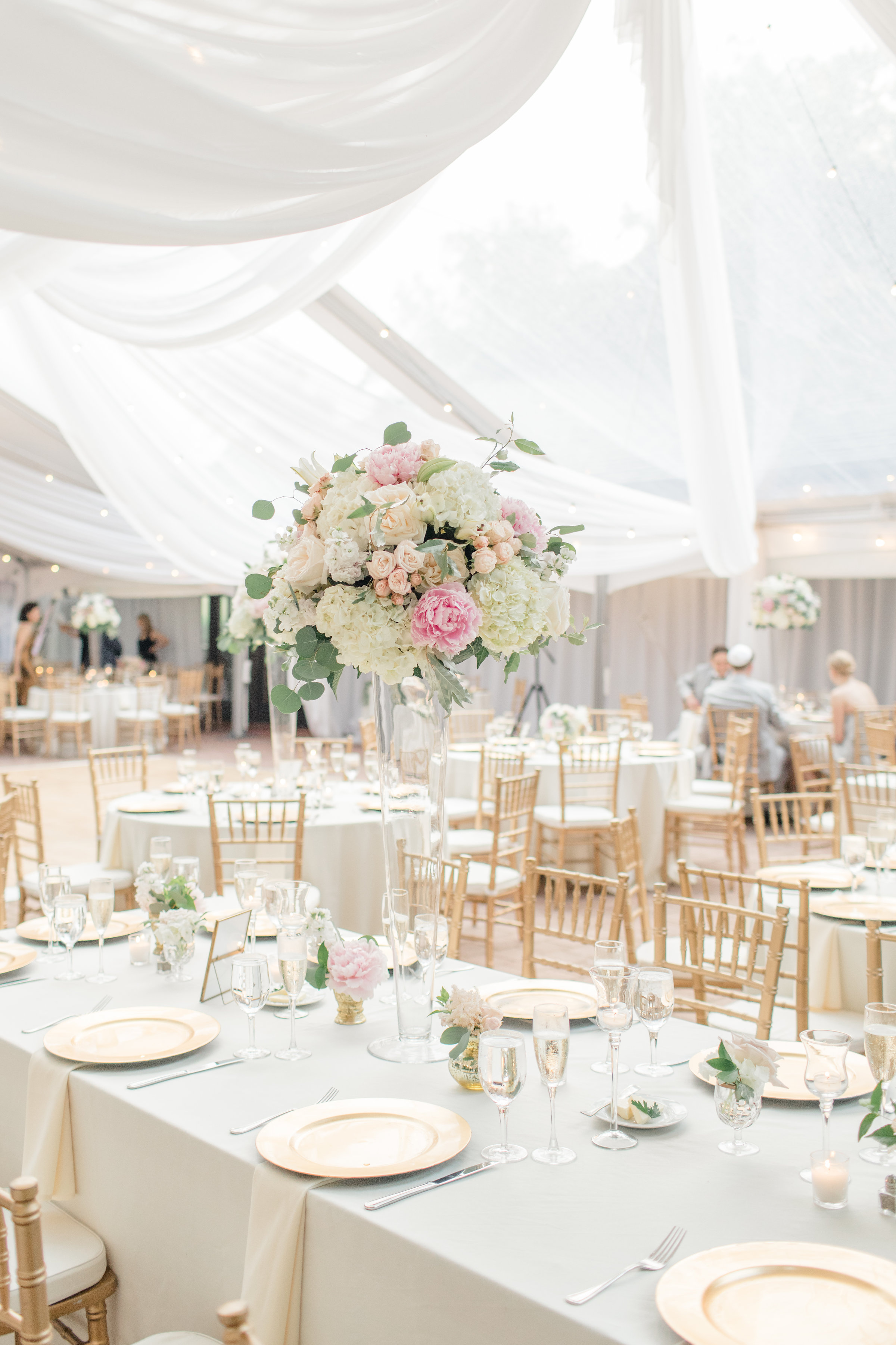 Tall blush and white centerpiece on glass vase