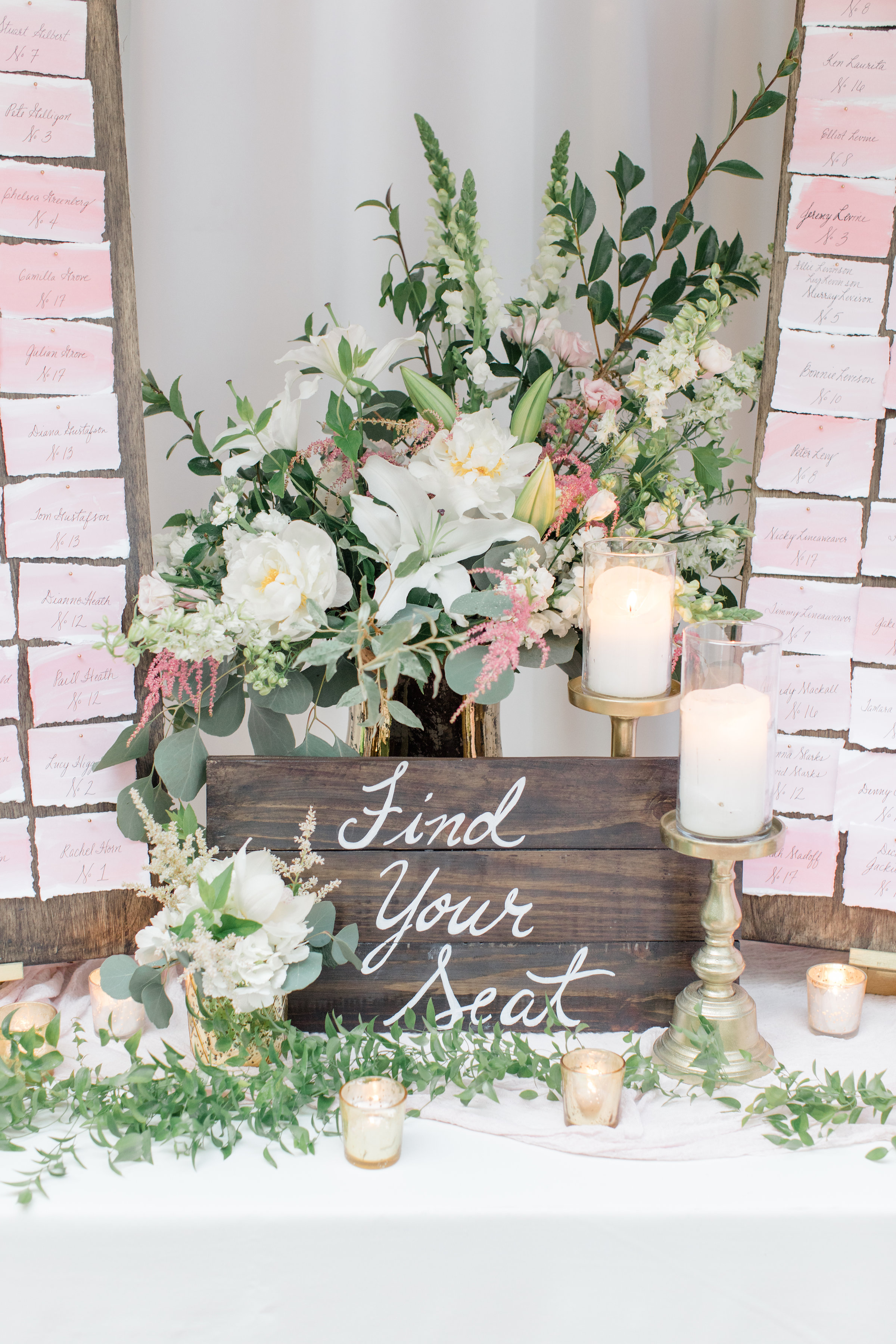 Fresh flower arrangement and find your seat sign