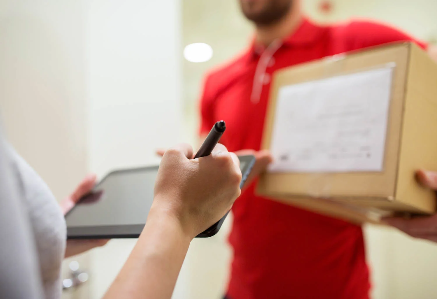 customer-with-tablet-pc-signing-for-parcel-PRWTMV2.jpg
