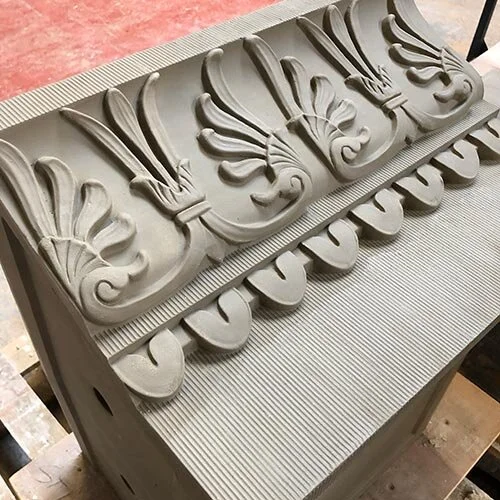 A decorative architectural element or molding with intricate floral patterns and scrolls.