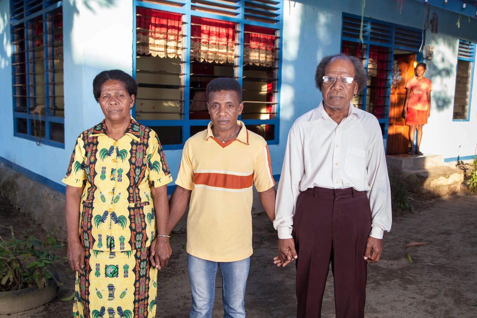 A portrait of Yosua with his supportive parents.