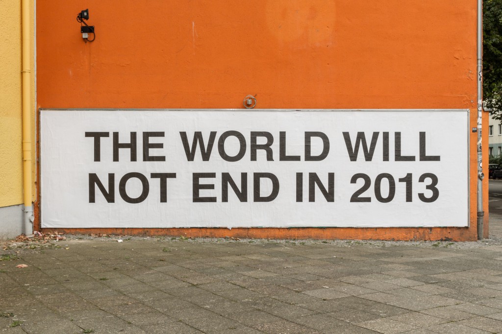 The World Will Not End as a billboard on the outside wall of the building that houses the Wand Gallery in Moabit, Berlin, Germany facing the Justizvollzugsanstalt prison, the most central prison in Berlin. In collaboration with Claus Philipp Lehmann. Inkjet print wallpaper. Font: Helvetica. Part of 'The Oracle exhibition curated by Melissa Steckbauer and Mathilde ter Heijne of ƒƒ