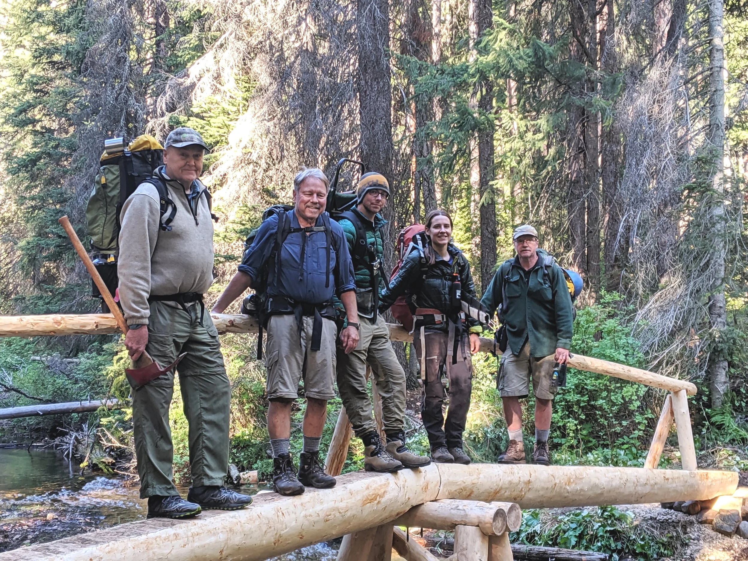 Volunteers and Interns stand on the newly constructed bridge. From Left to Right: Don Burgess, Pat Burke, Michael Riviere, Verena Gruber, Roger Green