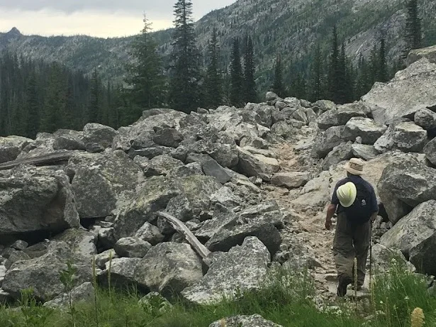 An SBFC volunteer hikes up the trail