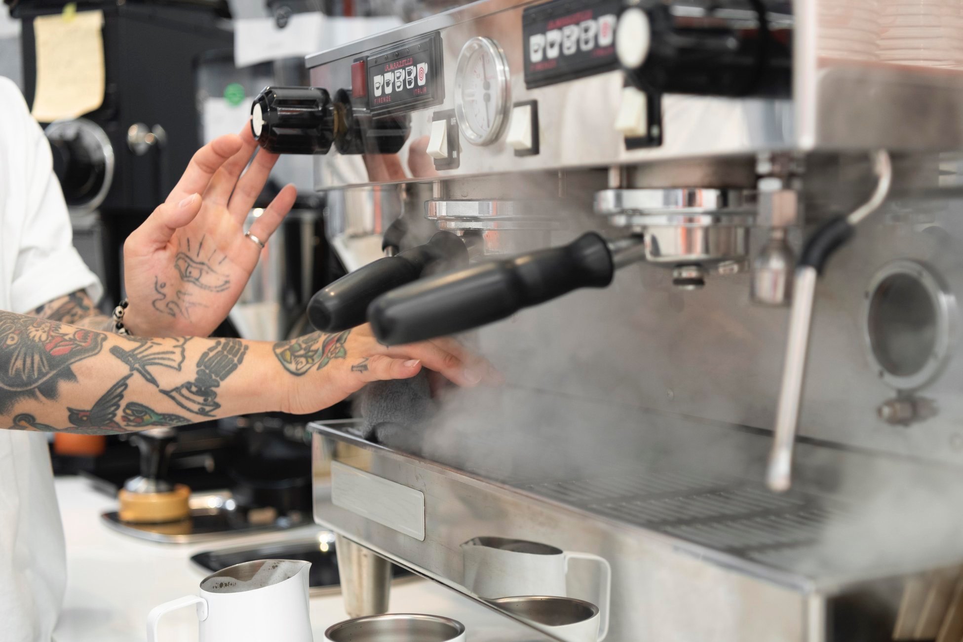 male-barista-with-tattoos-using-coffee-machine-coffee-shop.jpg