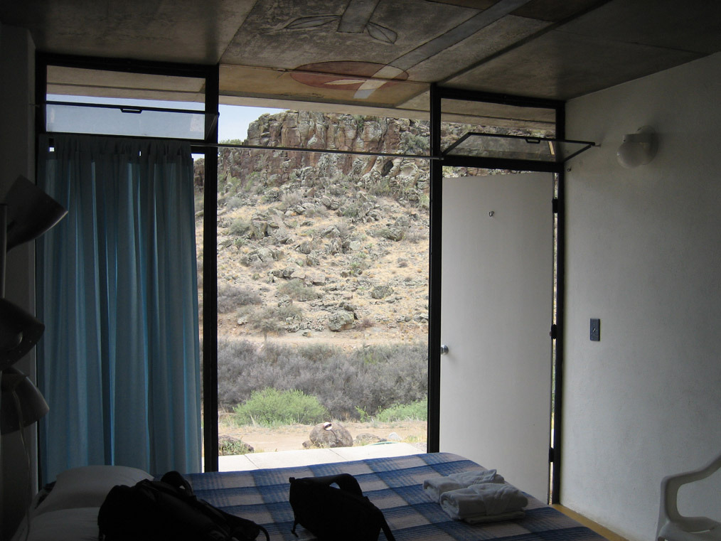 Guesthouse room with silt cast ceiling bridging interior and exterior.