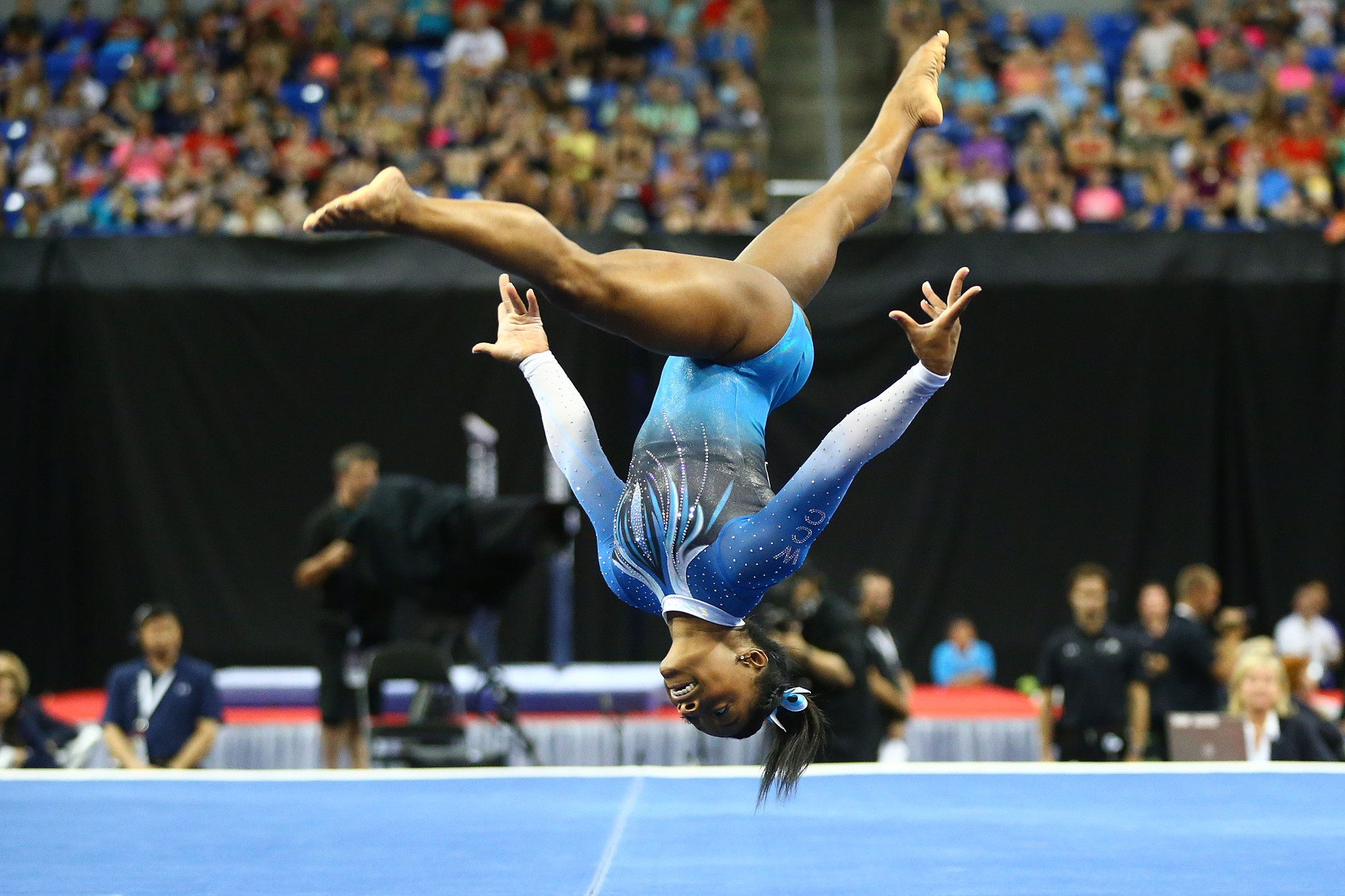 The floor exercise is about 40 feet long by 40 feet wide. The top layer is usually a carpet with a white marking around the perimeter. If the gymnast steps outside of this border, points are deducted from their scores. 
