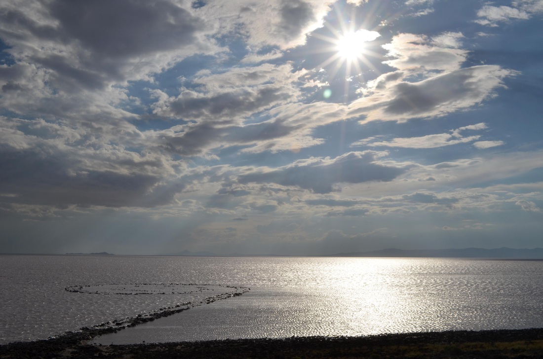 The water’s shimmering reflections added to the site’s dizzying effect within a vast expanse of nothingness. In the sky, spiral like clouds are shaping.