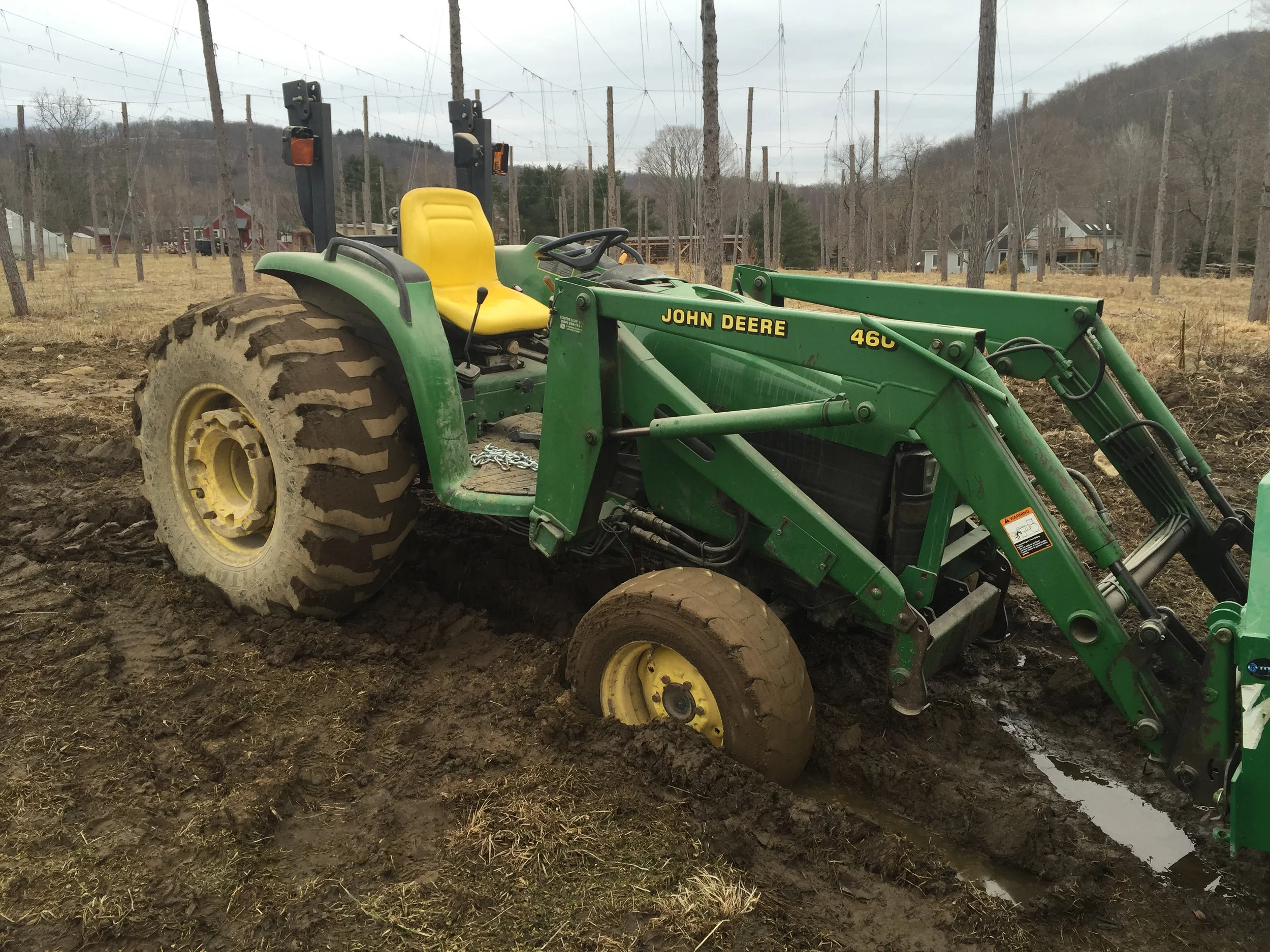 With the old farm came old farm equipment. Here's the old John Deere stuck up to the axel in mud.