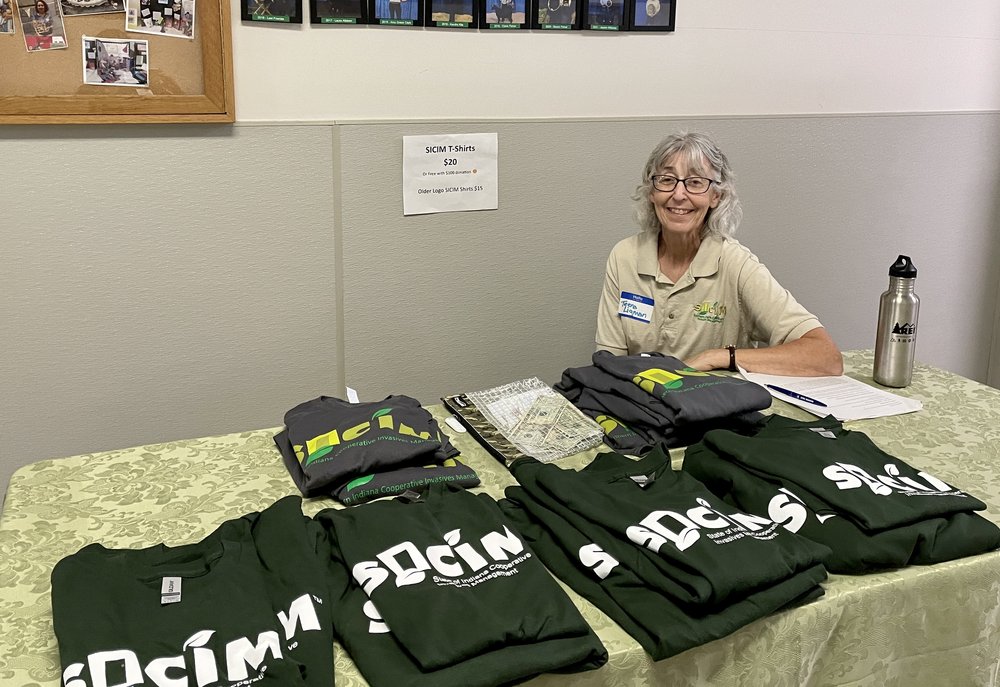  Teena Ligman, SICIM Board Secretary, selling SICIM tshirts 