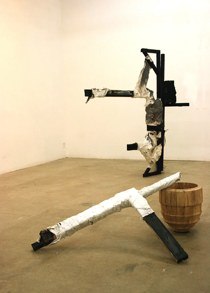 Totem for Laborers (installation view) Charred wood, carved sculpture, burlap and plaster bandages, turned wooden vessel, roofing tar Dimensions variable, 2015