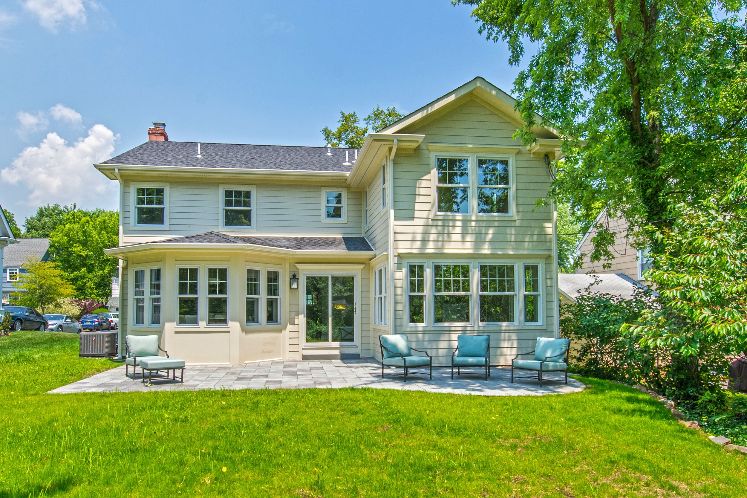 The completed rear of the house with new bluestone patio.