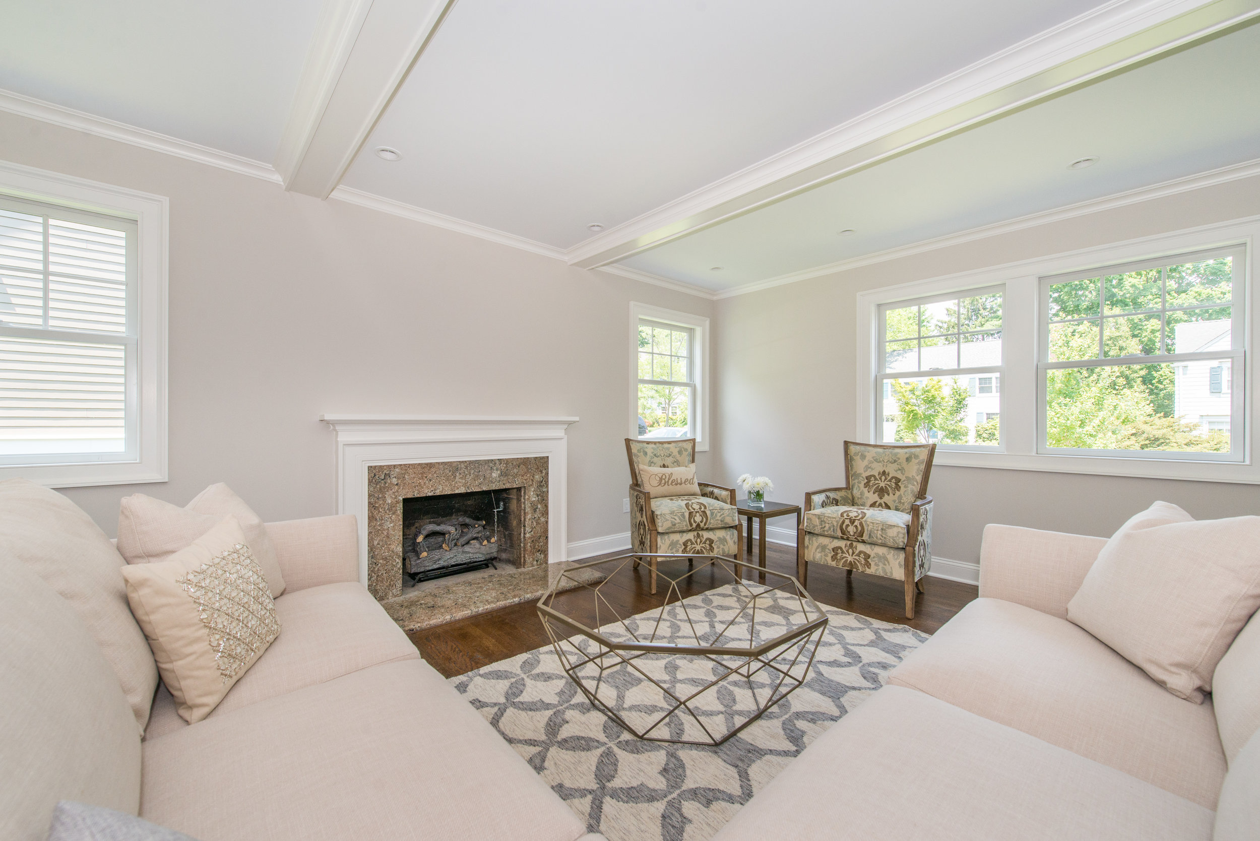 New Living Room is larger with gas insert fireplace and coffered ceilings