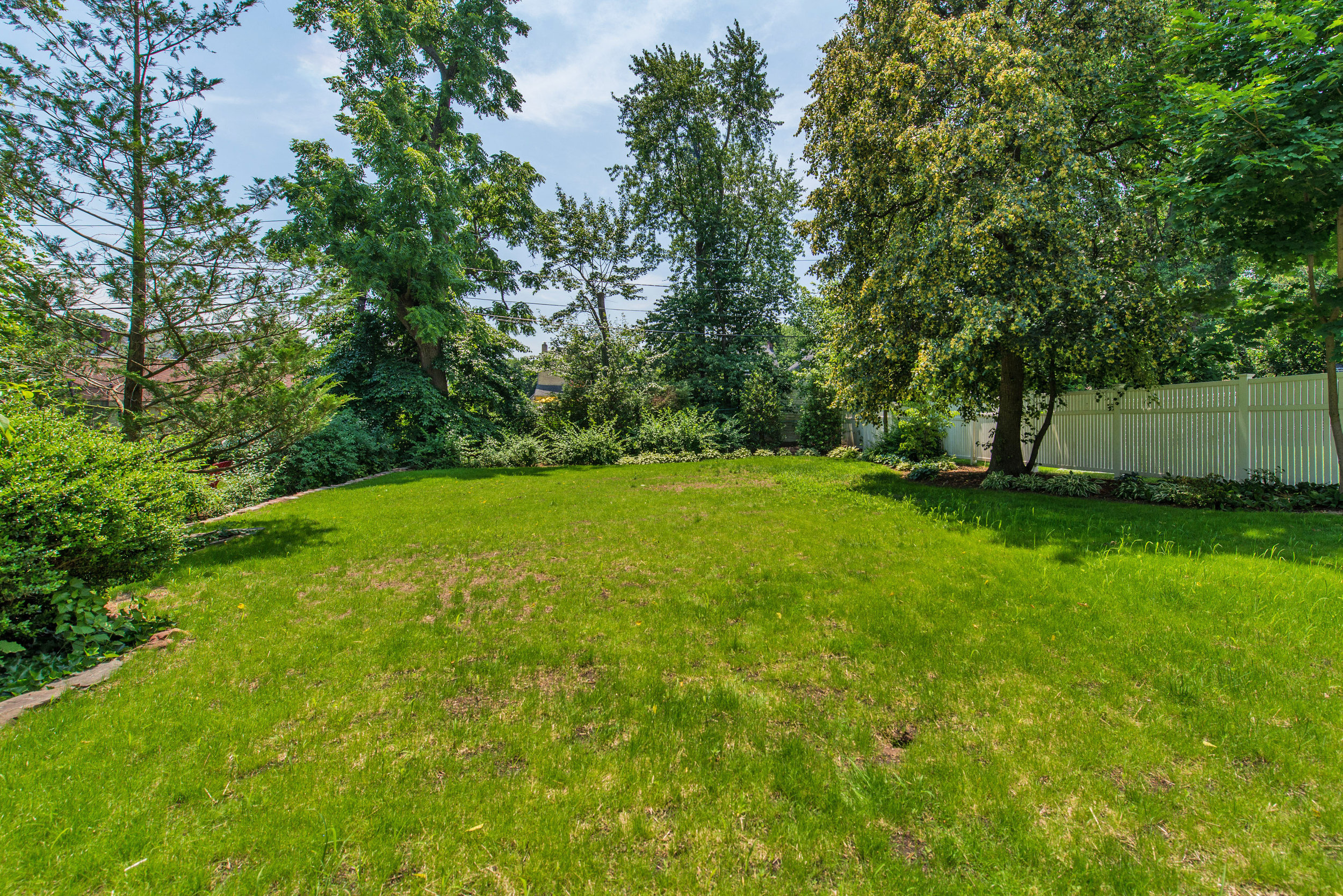 View of backyard which was leveled after the addition of the new Retaining wall on the left. 