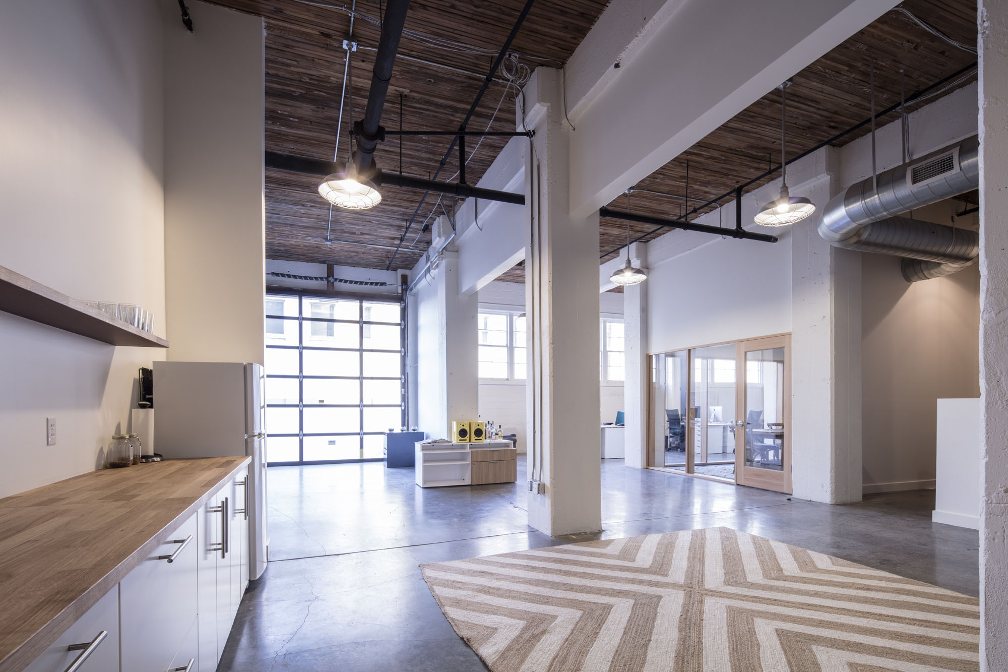 Location: Portland, OR Design: Green Gables Contruction: GGC Photography: Stefan Lerch Located within the Olympic Mills Commerce Center, GGC designed and built this creative office space in Portland’s Central Eastside Industrial District for the combined forces of Feast Portland – considered the country’s top food festival – and the public relations/media agency, Little Green Pickle . Transforming two existing suites into a single spacious office, the design integrates private and shared spaces that support their team’s flexible needs. The new wood and glass construction was inspired by the industrial character of the concrete and timber structure of the original historic warehouse.