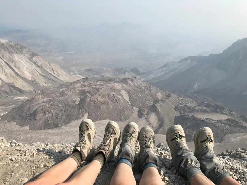Our weary dusty feet at the top of the volcano, looking into the crater.