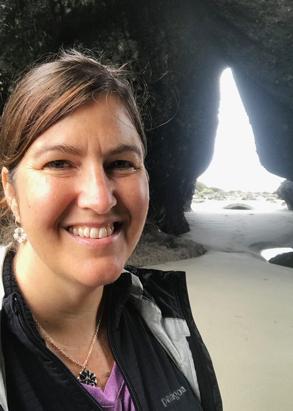 wearing silver rand black sea star nautical necklace with silver siren earrings in the sunshine at point of arches tunnel sea stack on shi shi beach washington.