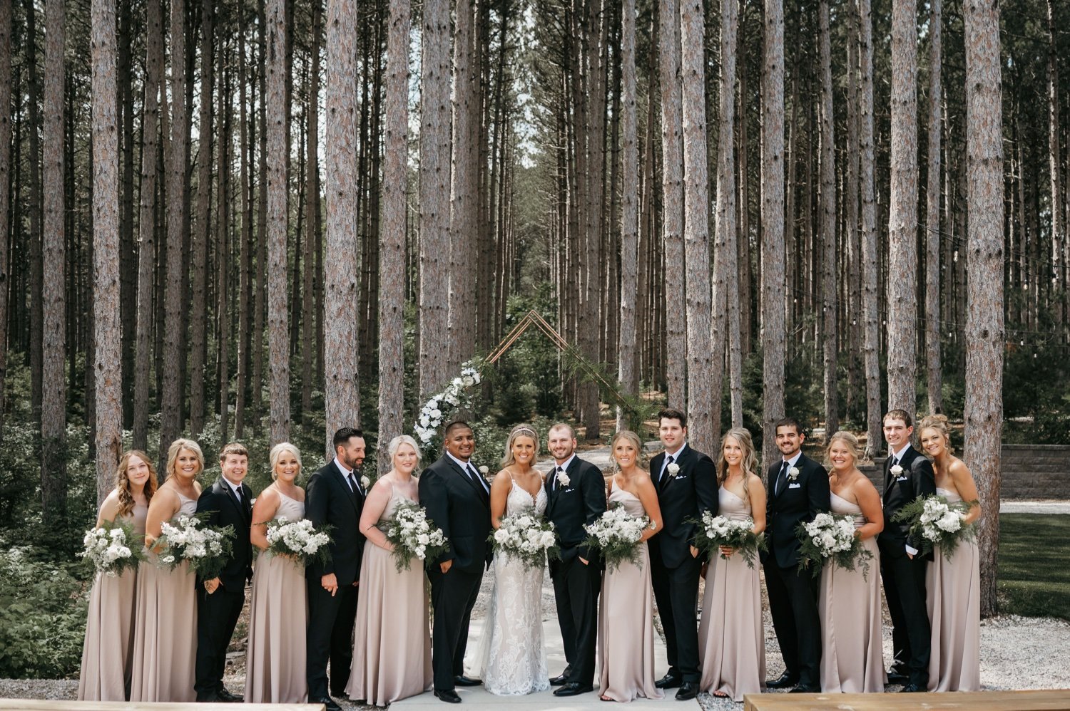 26_KFF_2055_wedding party photo in pine trees.jpg