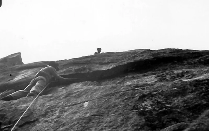 Bestor Robinson climbing and Richard Leonard belaying on the crux Flake pitch during the first ascent of Lower Spire, 1934.