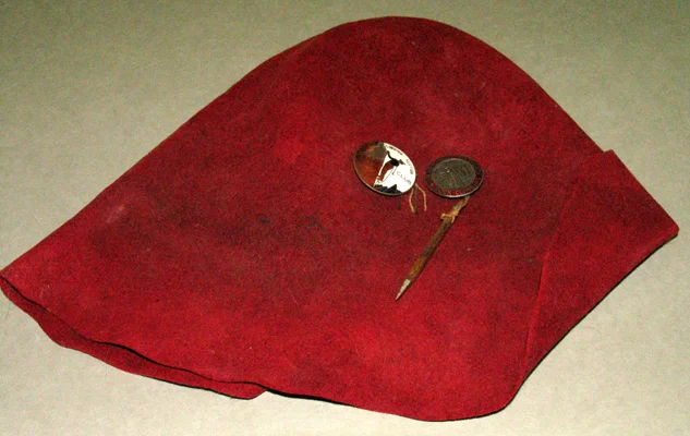 Felt hat that belonged to 1940's climber Robin Hansen. The hat has the first 2 metal pins given to RCS (Rock Climbing Section) members of the Sierra Club. The first pin on the left was designed by Torcum Bedayn. A second more durable pin was designed by Ronald Hahn after it was discovered that Torcum's baked enamel pin chipped while climbing. Robin Hansen is best known for being the one that suceeded in throwing the rope over the Lost Arrow Tip during the first ascent in 1946. This "rope trick" as Salathe called it, spurred Salathe to climb to the Lost Arrow Tip starting from the bottom of the wall with Ax Nelson who was on the 1946 ascent. They called their route, the Lost Arrow Chimney, and completed it in 4 1/2 days in 1947 making it Yosemite's first big wall.