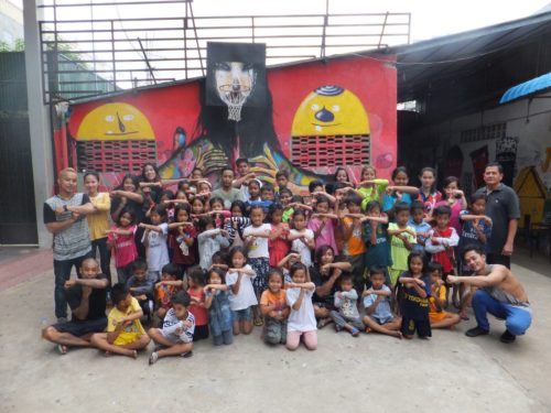 Members of theTiny Toones youth arts charity in Phnom Penh, Cambodia in front of the David Choe mural produced for Igloo Hong art interventions in Cambodia in 2016. Learn more about Tiny Toones here