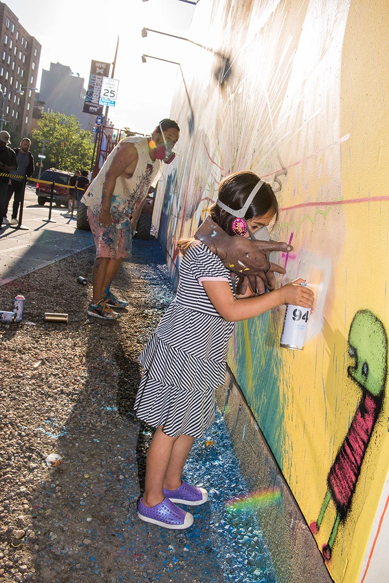  Young girl painting alongside artist David Choe at the Bowery graffiti wall in New York. Photo by Martha Cooper. 