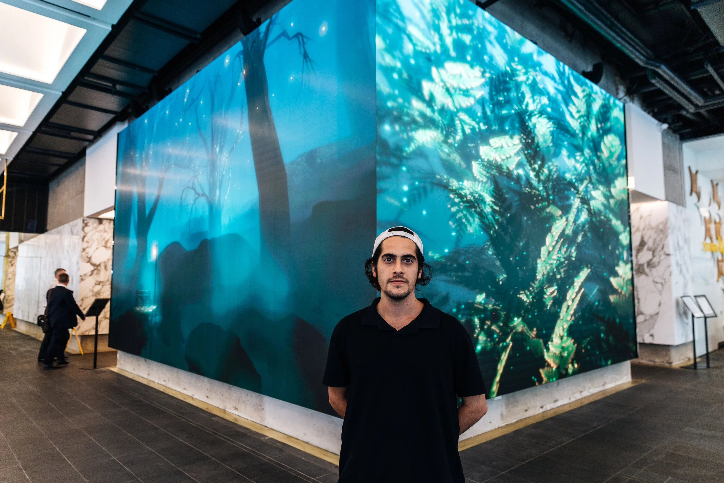 Artist Matt Schembri in front of his digital artwork at 100 Creek Street, Brisbane. Credit: Art Pharmacy Consulting/Savannah van der Niet
