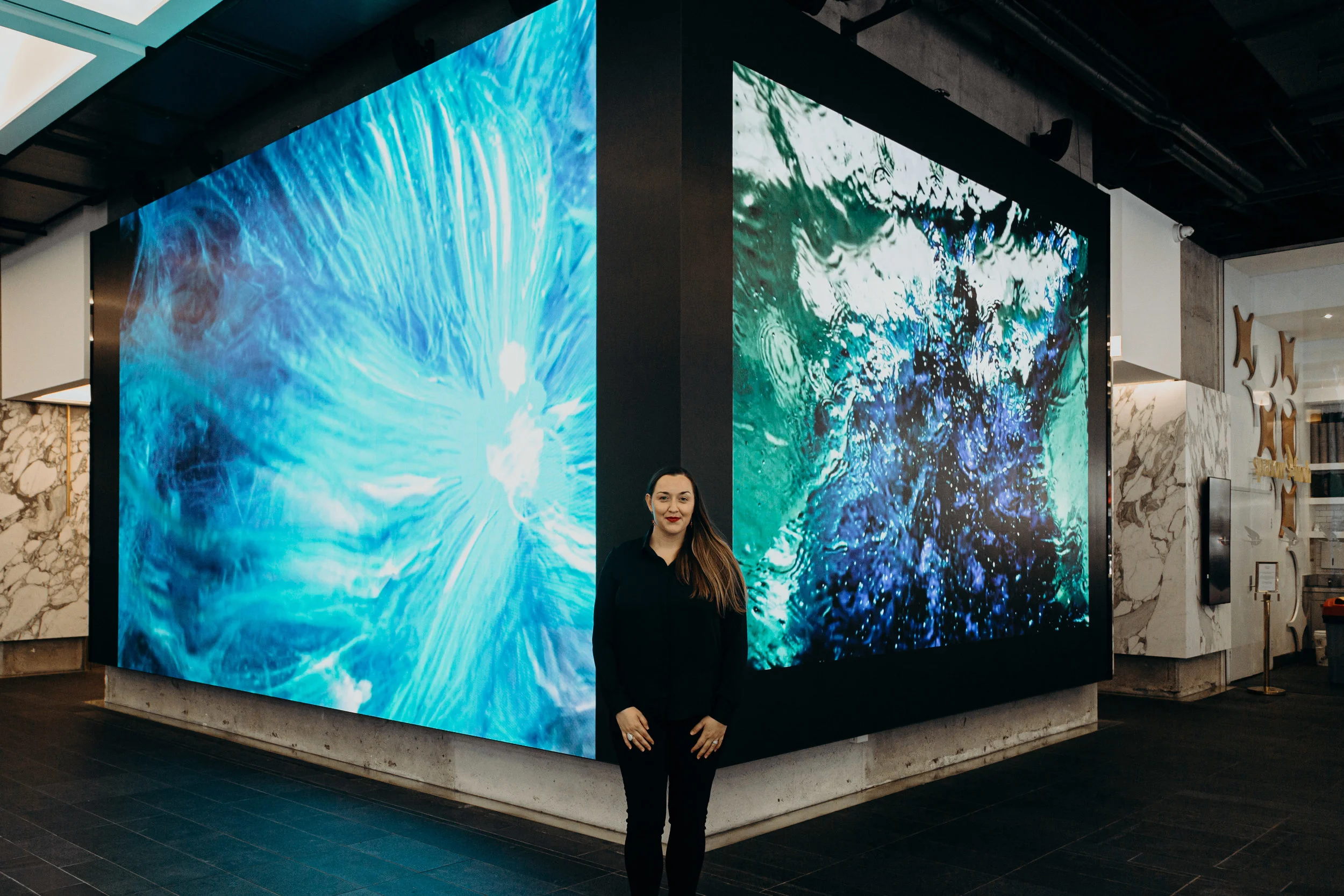 Stefania Shevchenko with her digital artwork, Space - Ocean Continuum. Image credit: Art Pharmacy Consulting / Anwyn Howarth.