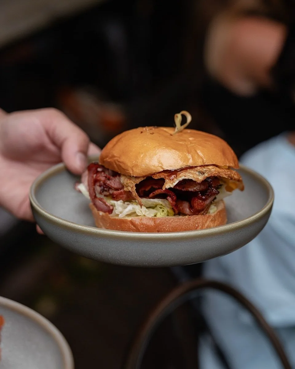 Bacon &amp; Egg Roll
Crispy bacon, fried egg, cheese &amp; house BBQ sauce on a toasted milk bun.

Harissa Mushrooms
Roasted mushrooms tossed in house harissa, served on toasted sourdough with spinach, Goat cheese, Crispy Enoki.

Okonomiyaki
Japanese