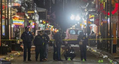 New Orleans police study the crime scene after a fatal shooting on Sunday. (Matthew Hinton/The Advocate via AP)