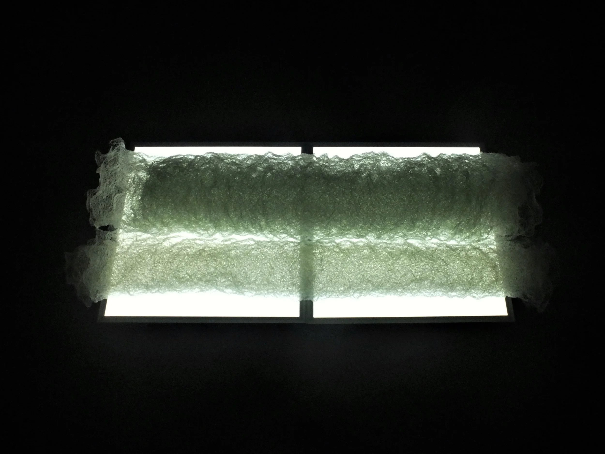 Abulon (Avalon), rolled, 2018, hand-knitted fishing line, two LED rectangular lights. approximately 150x60x30cm. As exhibited at Arkivet för temporär konst, Sickla industriväg 6a, 1-4 November 2018.