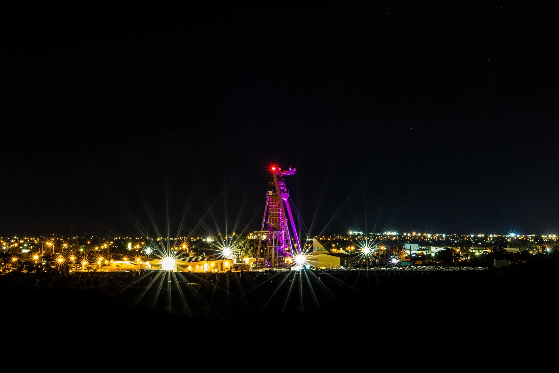 Mount Charlotte Underground Mine’s Cassidy Headframe lit in pink and blue lights to celebrate the announcement. Credit: Jarrod Lucas, ABC Goldfields-Esperance.