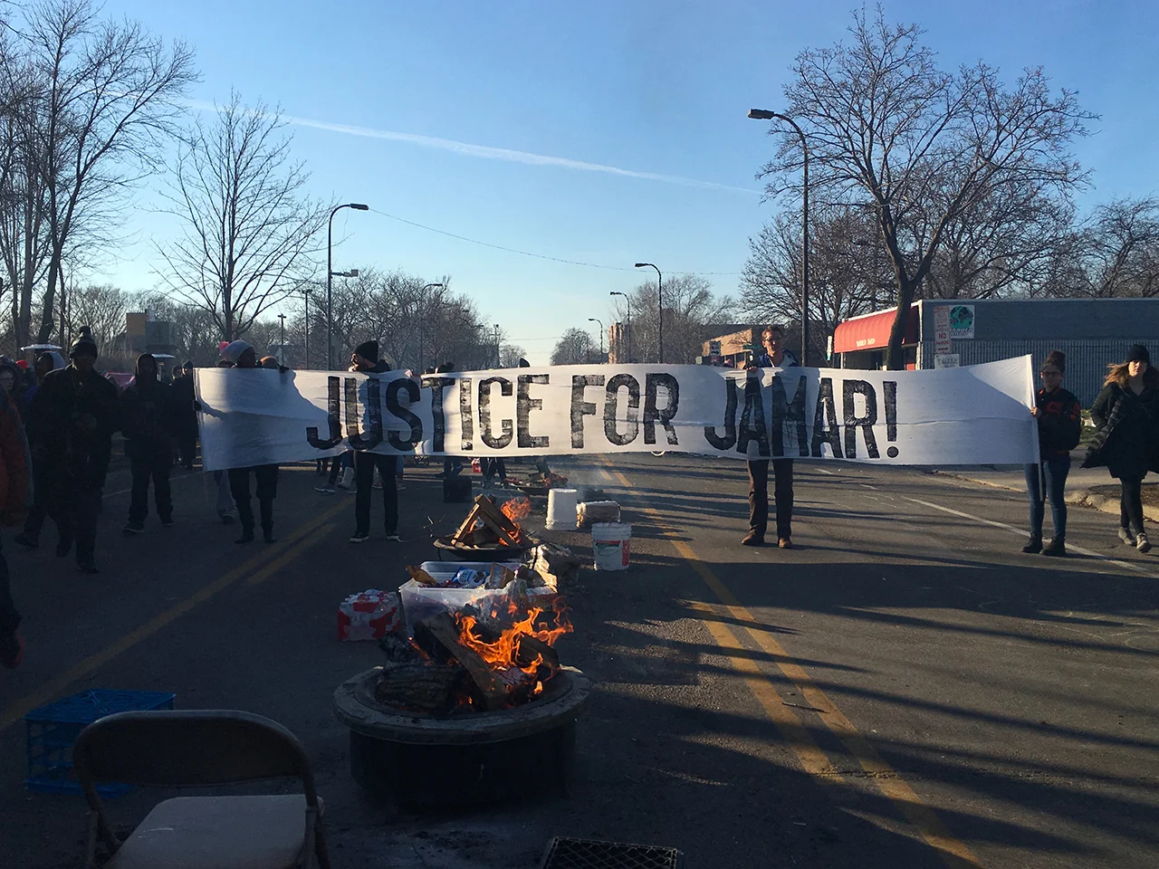 A banner, created using artist Piotr Szyhalski's "insanely dysfunctional letterpress setup,” in use at the late-2015 Black Lives Matter encampment outside a north Minneapolis police precinct HQ.
