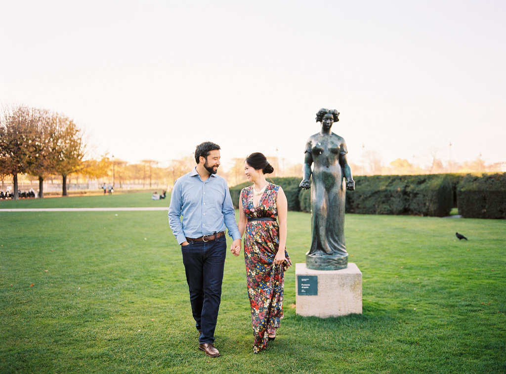 Couple walking in Tuileries Garden in Paris Engagement session