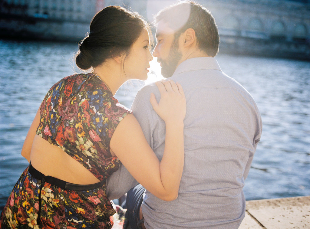 Couple kissing along river La Seine Parisian elopement