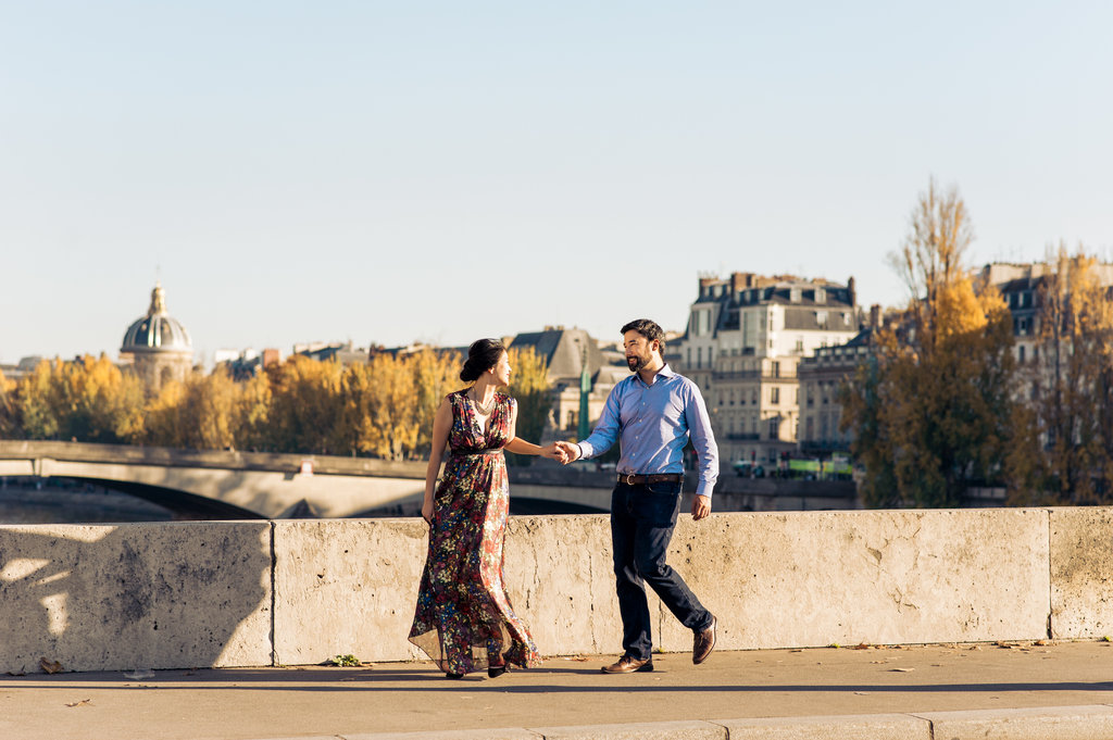 Walking along river Seine in Paris hand in hand anniversary session