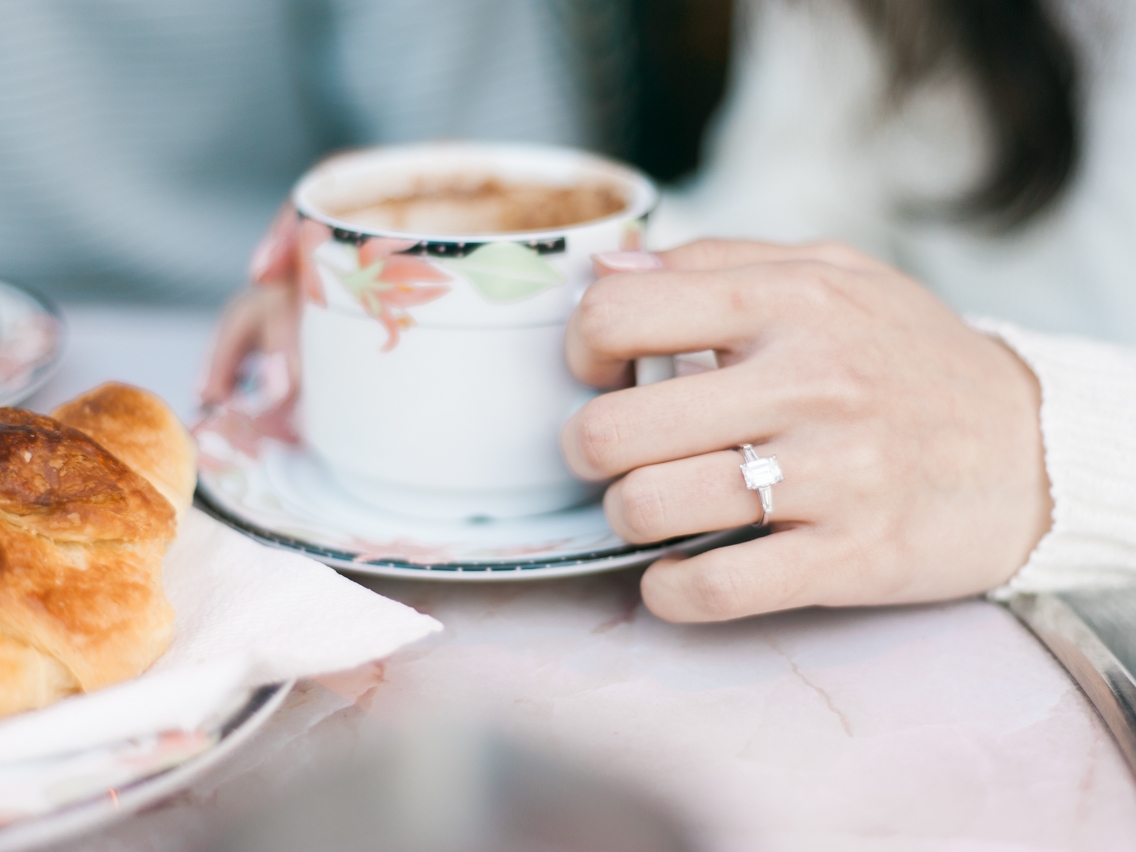 Engagement ring with coffee and croissant in Paris