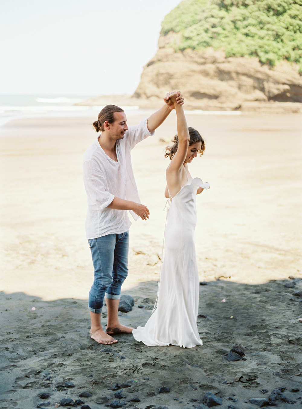 Couple dancing on the beach for their wedding