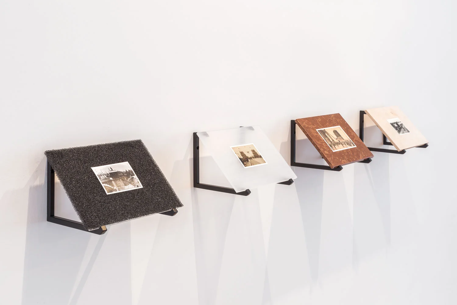 ÁDÁM ALBERT COVERED UP TOLL COLLECTOR BOOTHS, 2018 Mixed media, 4 pieces, each: 24 x 34 cm Courtesy of Ádám ALBERT, Photo: Gábor Arion KUDÁSZ 4 Prints: NO. 1. THE DECORATED BRIDGEHEAD OF THE FRANZ JOSEPH BRIDGE ON THE BUDA SIDE Gicleé print, plywood, different materials, 24 x 34 cm NO. 2. CROWD HEADING FROM PEST TO BUDA AT THE ELISABETH BRIDGE Gicleé print, lime-stone, different materials, 24 x 34 cm NO. 3. DECORATION OF THE RAMP TO THE ISLAND FROM THE MARGARET BRIDGE Gicleé print, plexi, different materials, 24 x 34 cm NO. 4. THE DECORATED BRIDGEHEAD OF THE MARGARET BRIDGE ON THE PEST SIDE Gicleé print, polyurethane foam, different materials, 24 x 34 cm