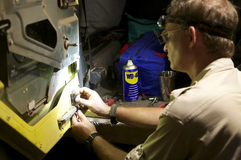 Fundi (mechanic) Gary Haynes working on a door latch