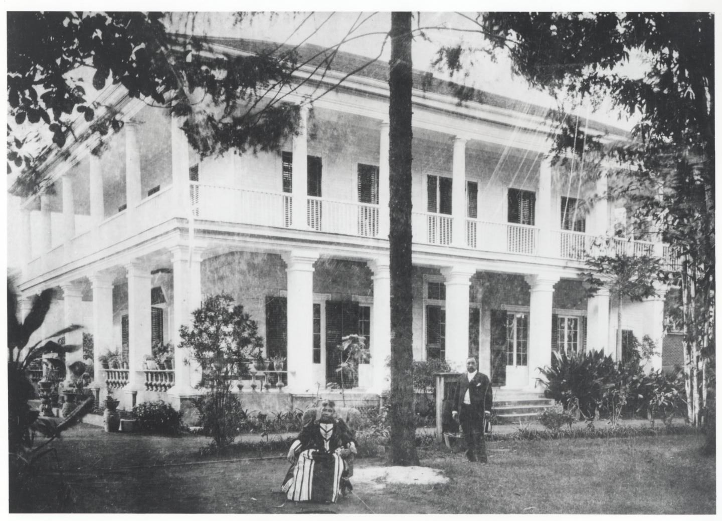  Queen sitting on the front lawn.   Hawaii State Archives  
