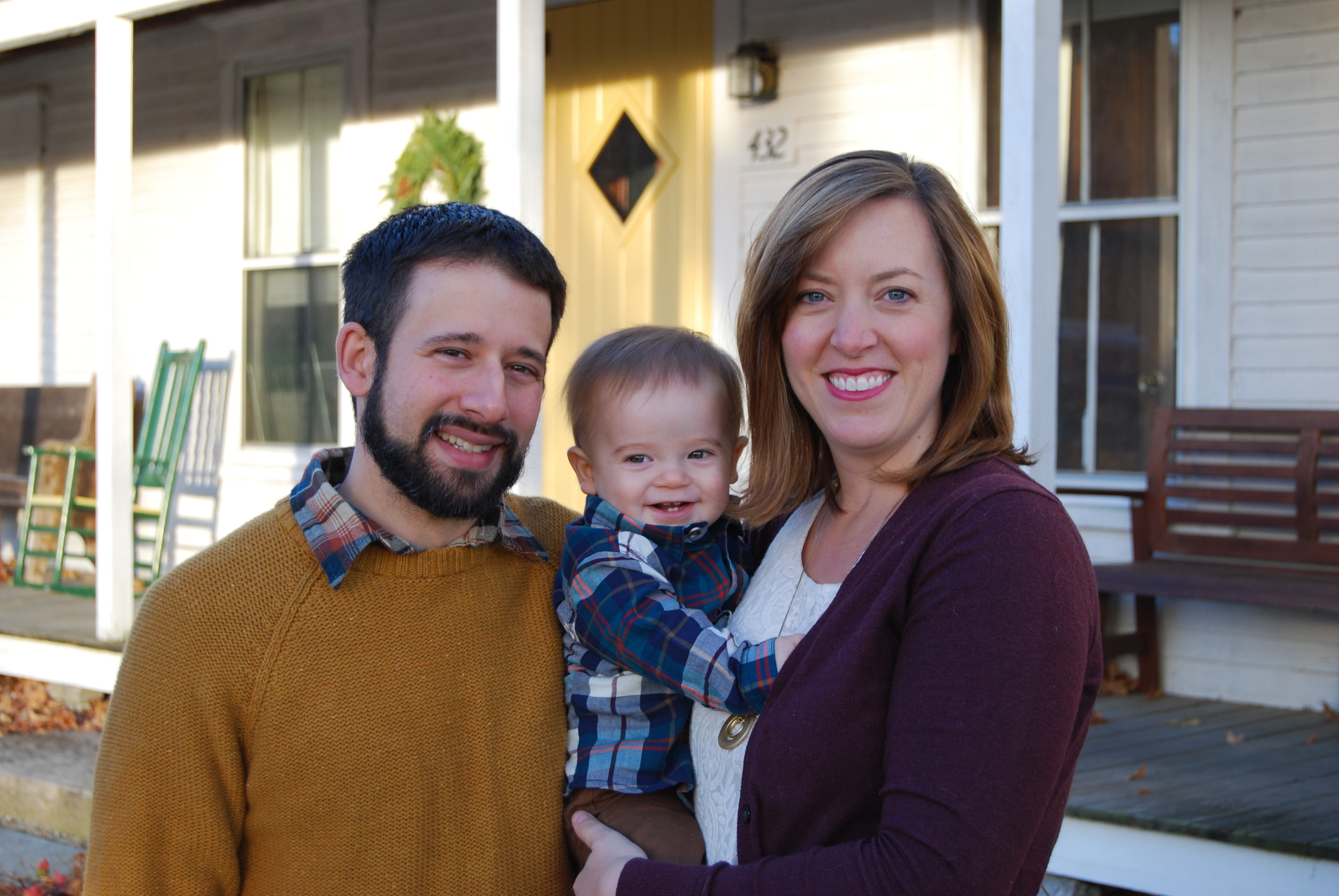 Rich and Sarah with their son, Richard in front of the farmhouse.