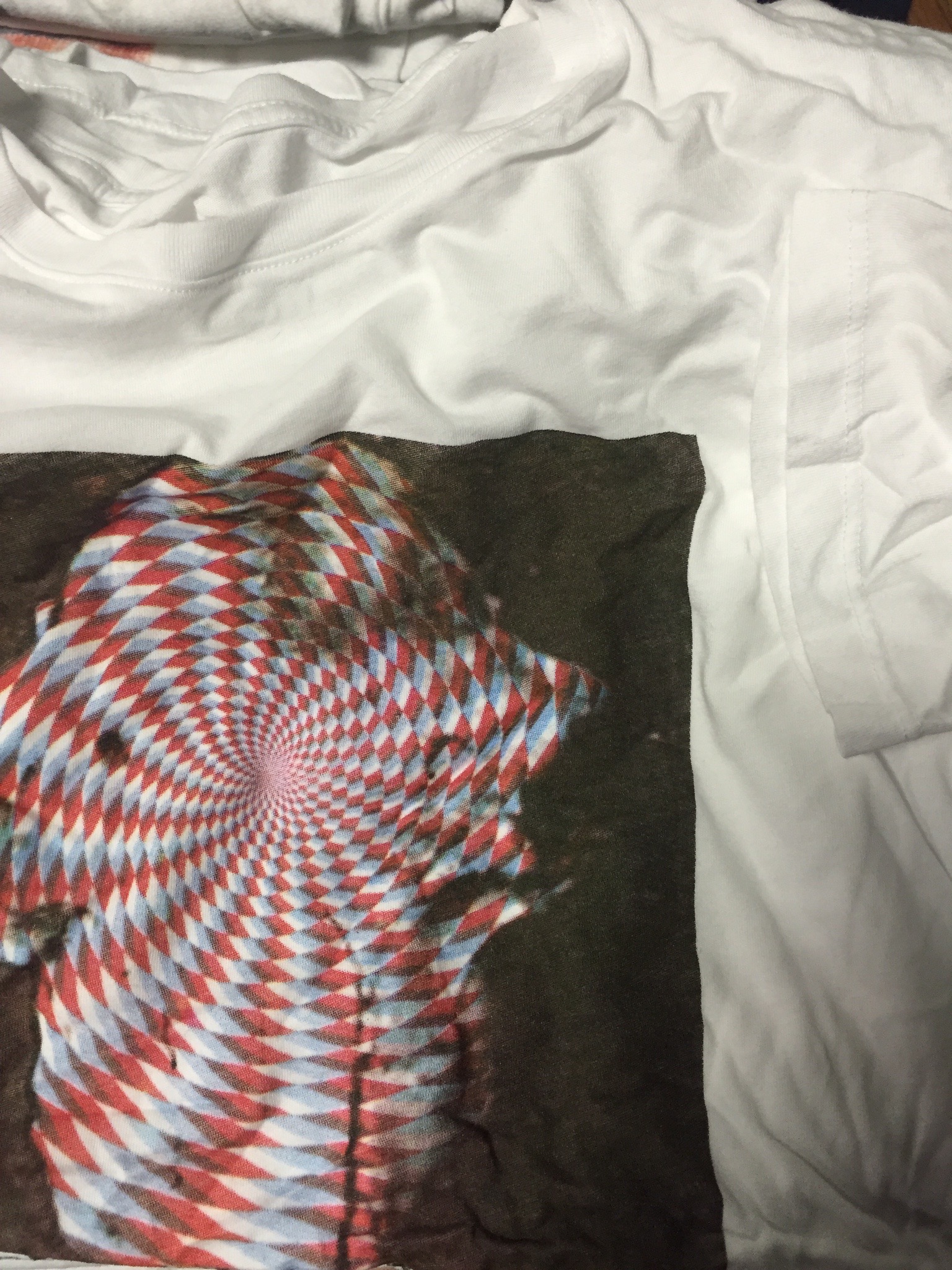 Custom specialty screen printing on streetwear apparel featuring an optical spiral graphic.