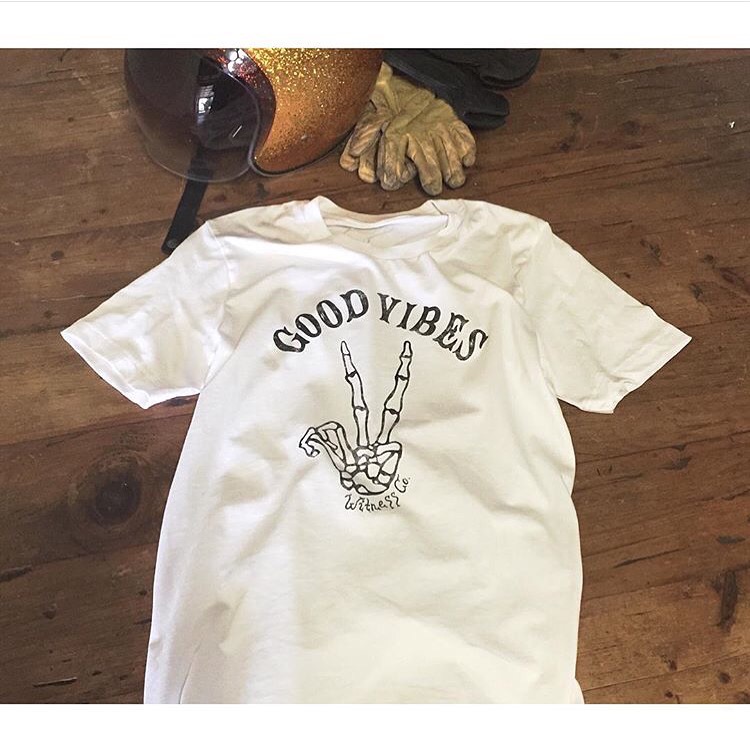 Soft-hand custom screen printing on boutique retail apparel featuring a Good Vibes graphic.