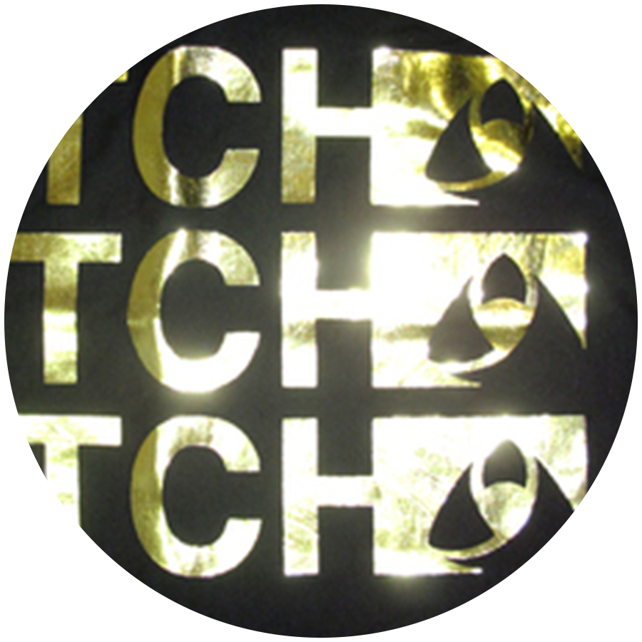 Custom specialty metallic gold foil screen printing finish on a dark apparel garment.