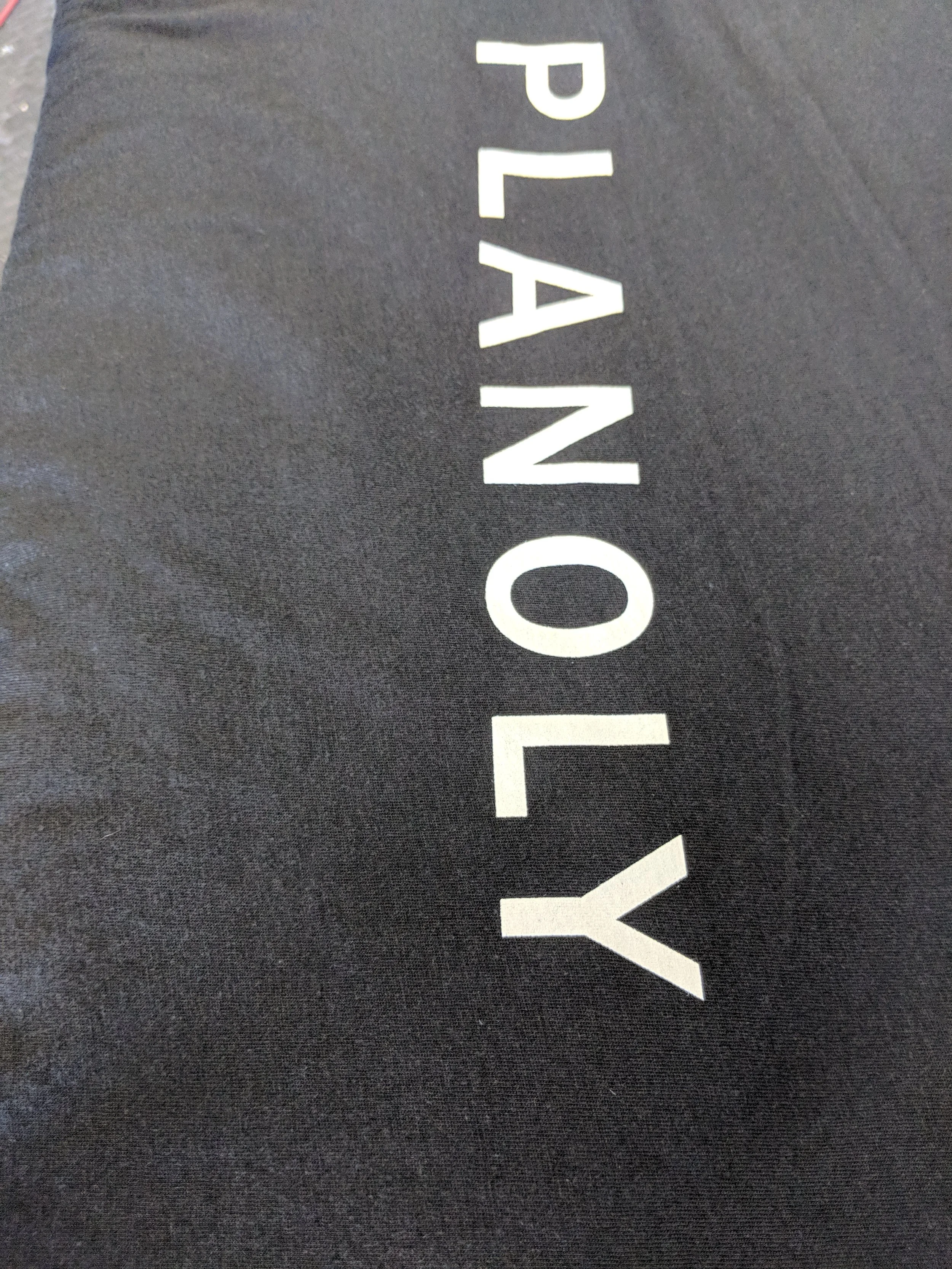 Retail-quality custom screen printing on dark startup apparel manufactured for Planoly.