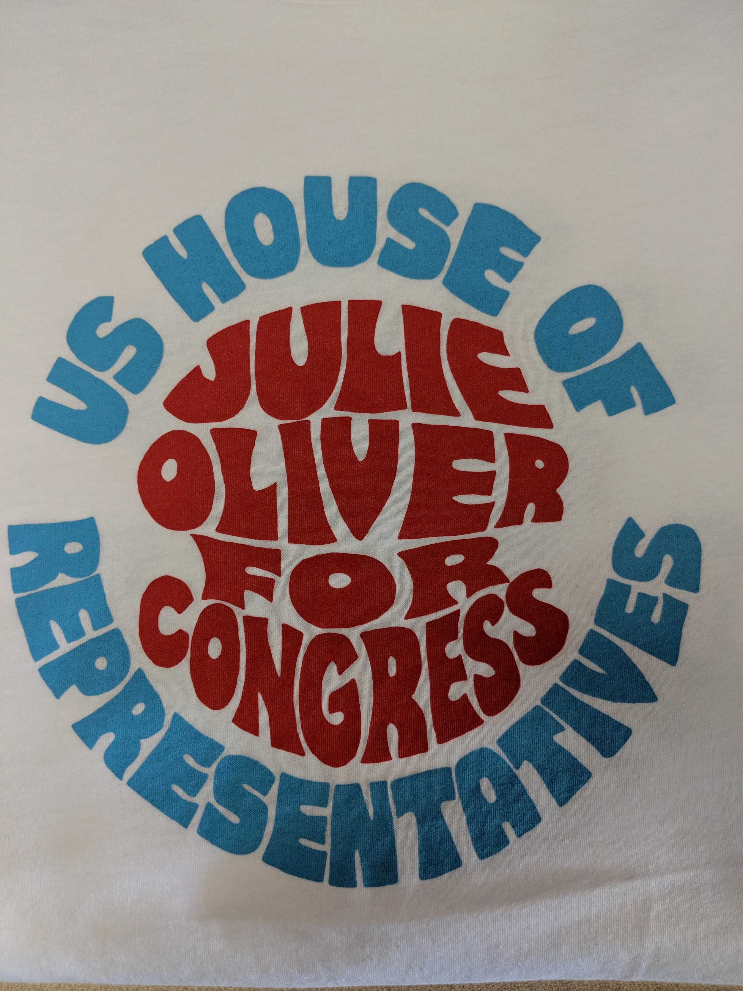 Custom screen printed political campaign event merchandise reading US House of Julie Oliver for Congress.