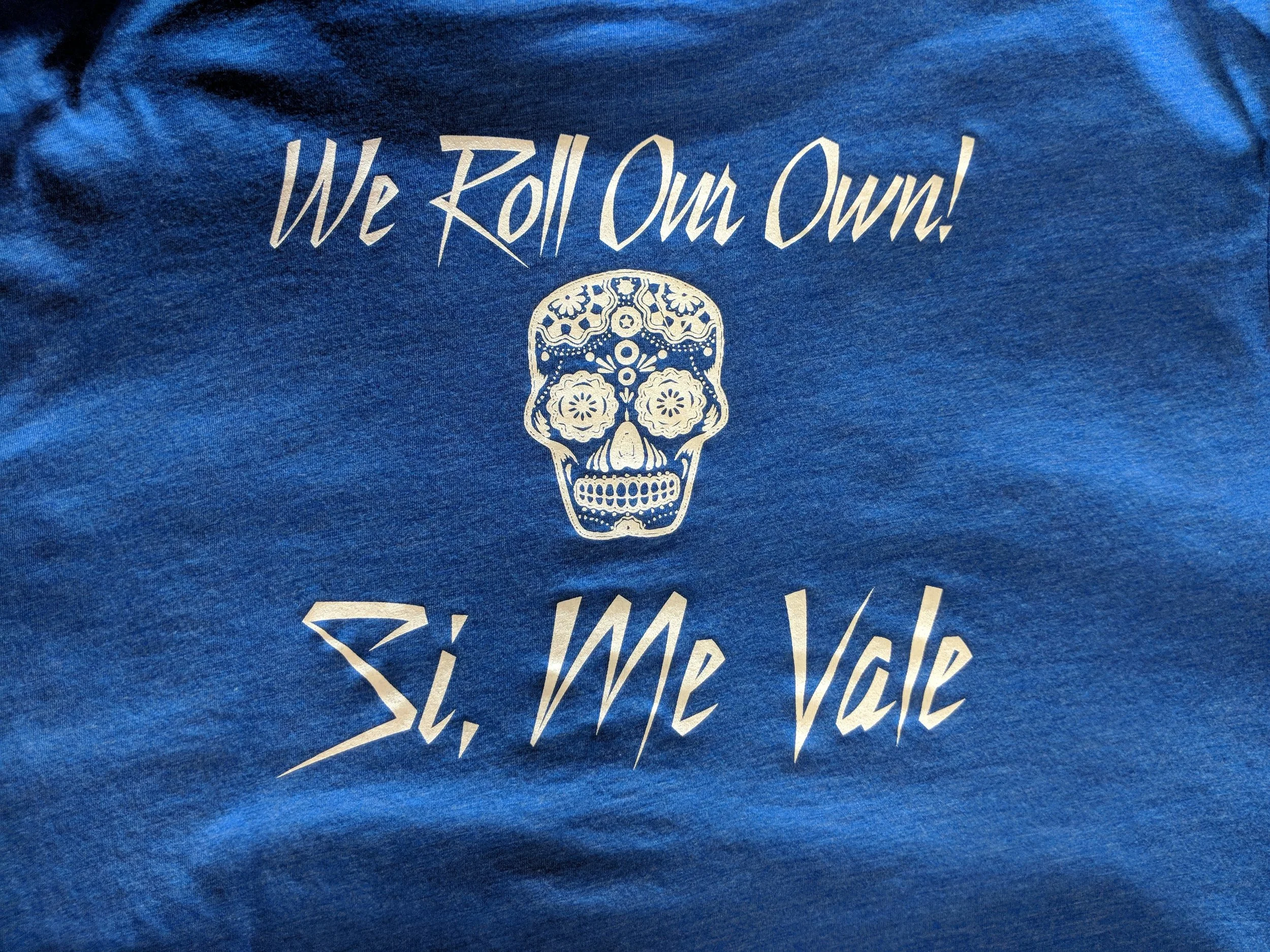 Custom screen printed restaurant merchandise reading We Roll Our Own produced for Taco Joint in Texas.